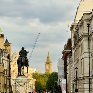 a statue of a man riding a horse on a city street