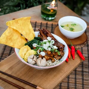 a bowl of food sitting on top of a wooden table